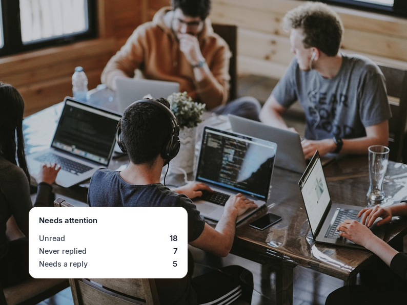 visual showing an agency team around laptops beside a shared inbox counter